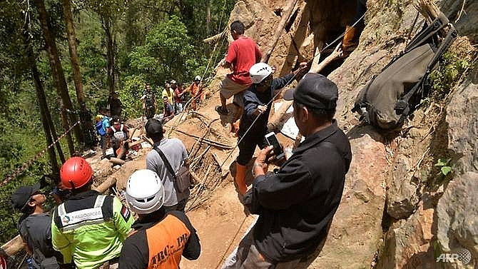 Eight dead in Indonesia mine collapse as excavator digs for survivors